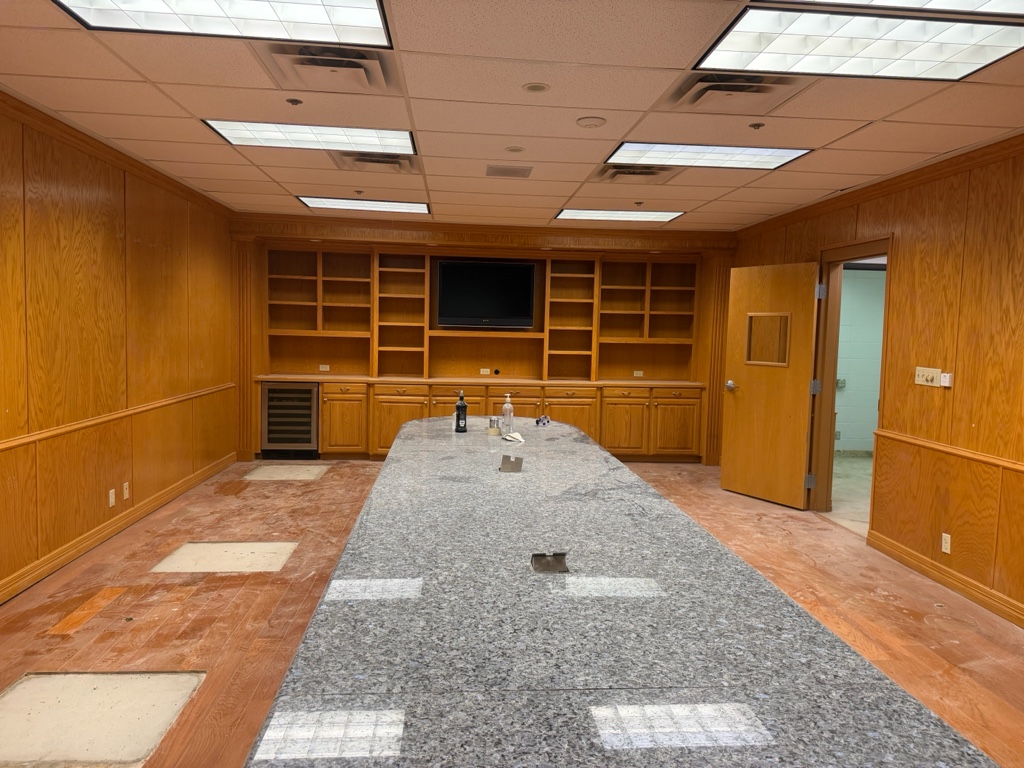Conference room with the carpet back in place after the repair
