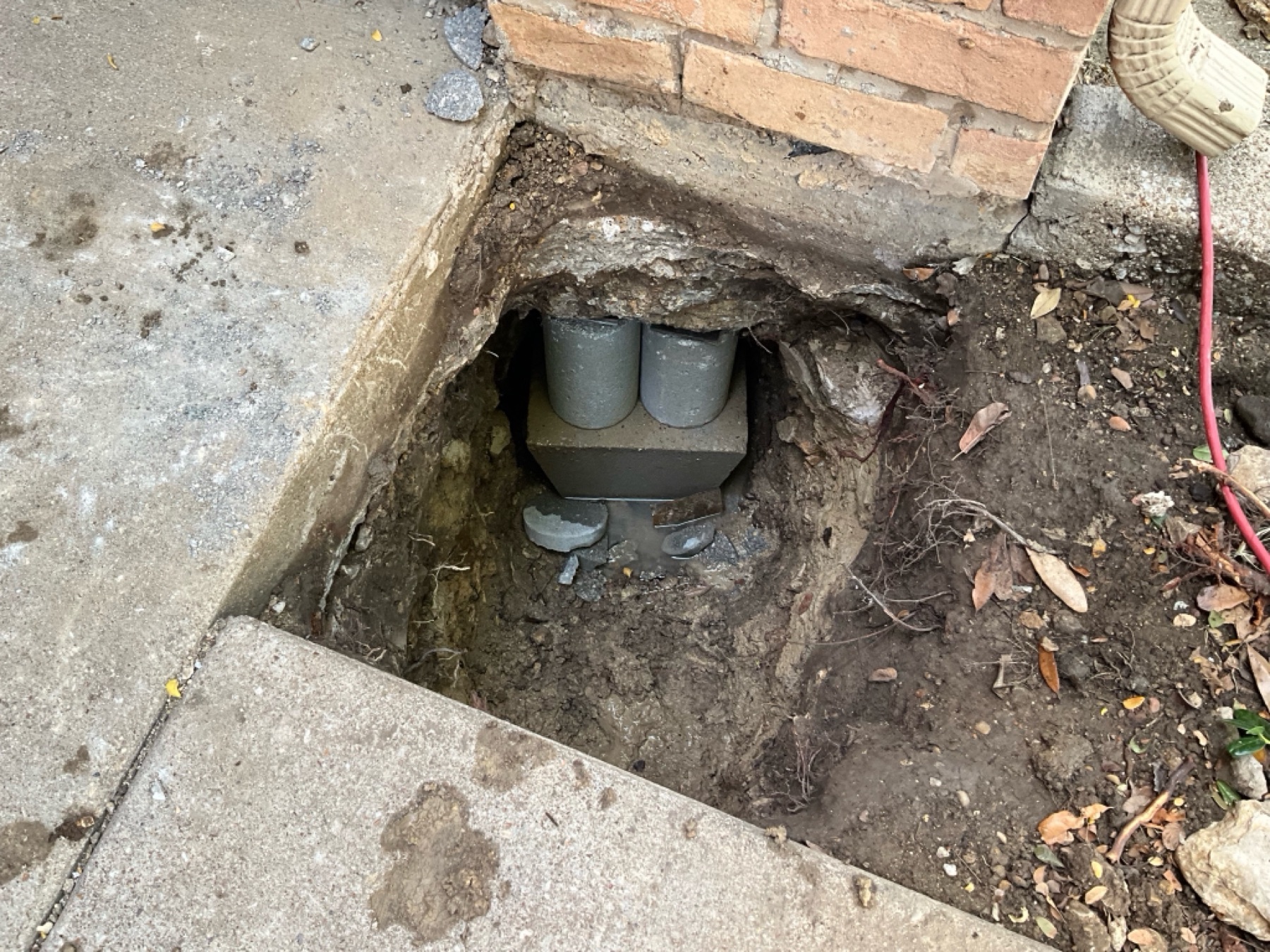 Pier and cap seated tight under the grade beam at the sidewalk edge