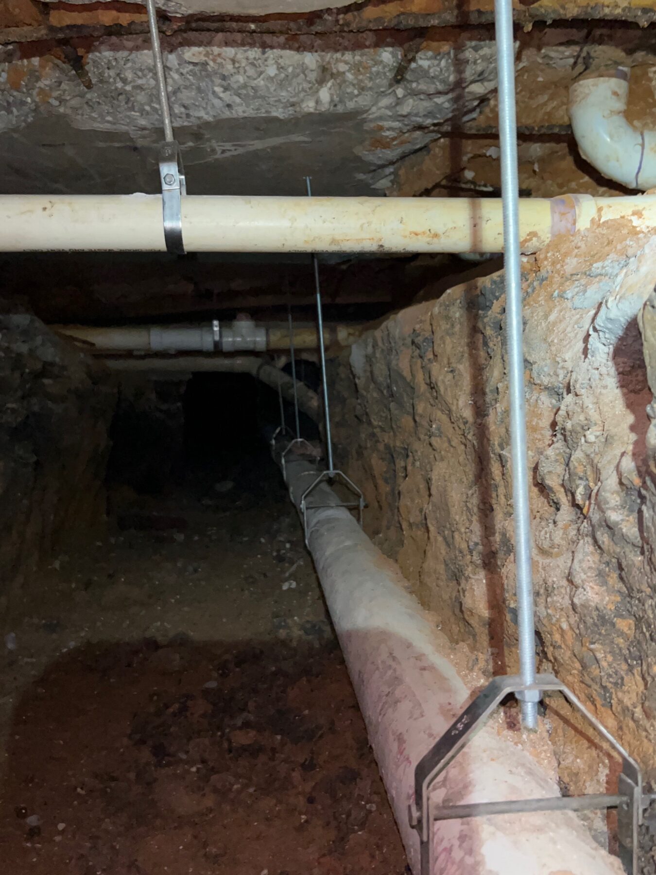 New sewer line hung and supported in the foundation tunnels