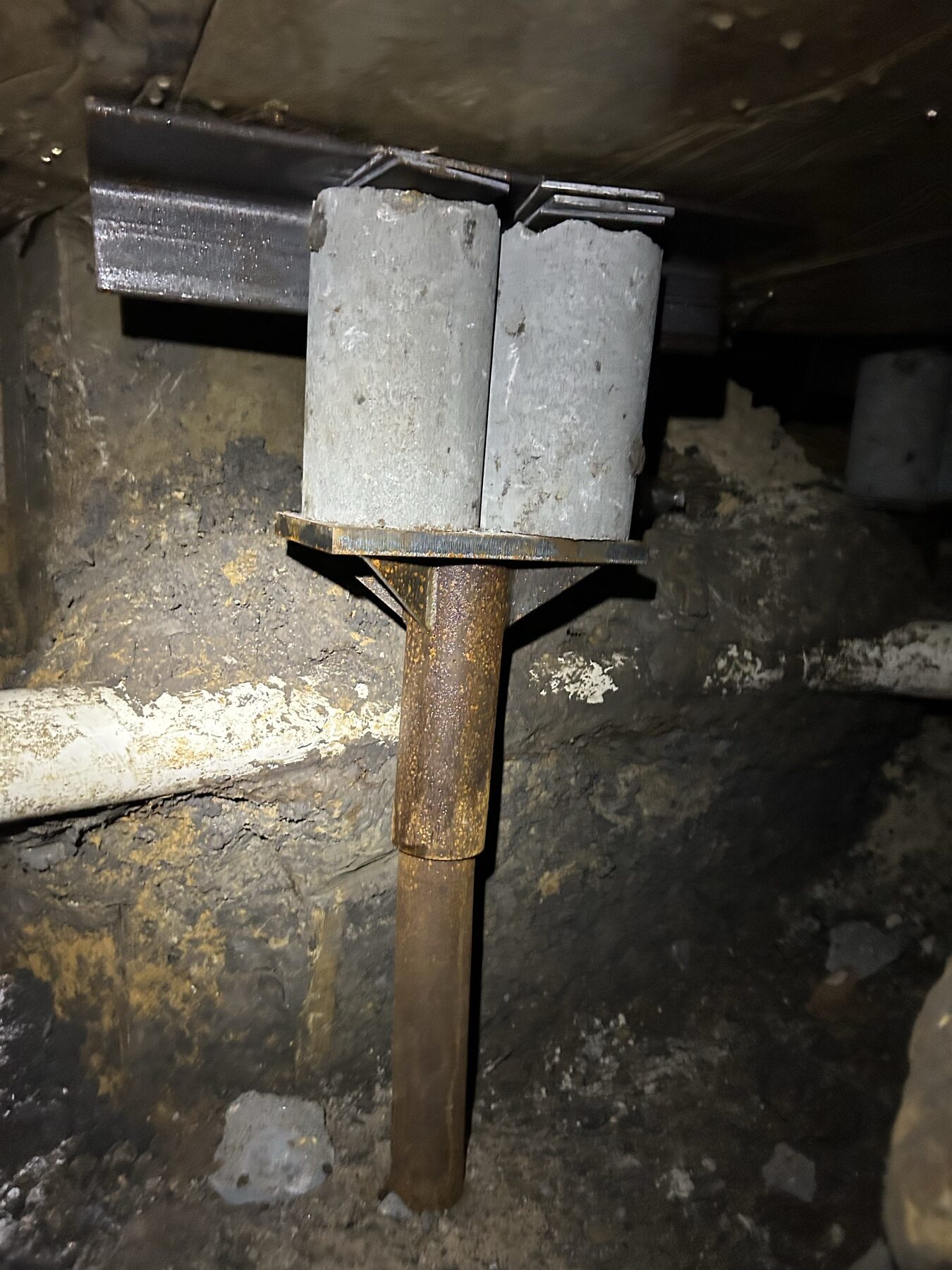 Pier bracket and caps tight under the grade beam